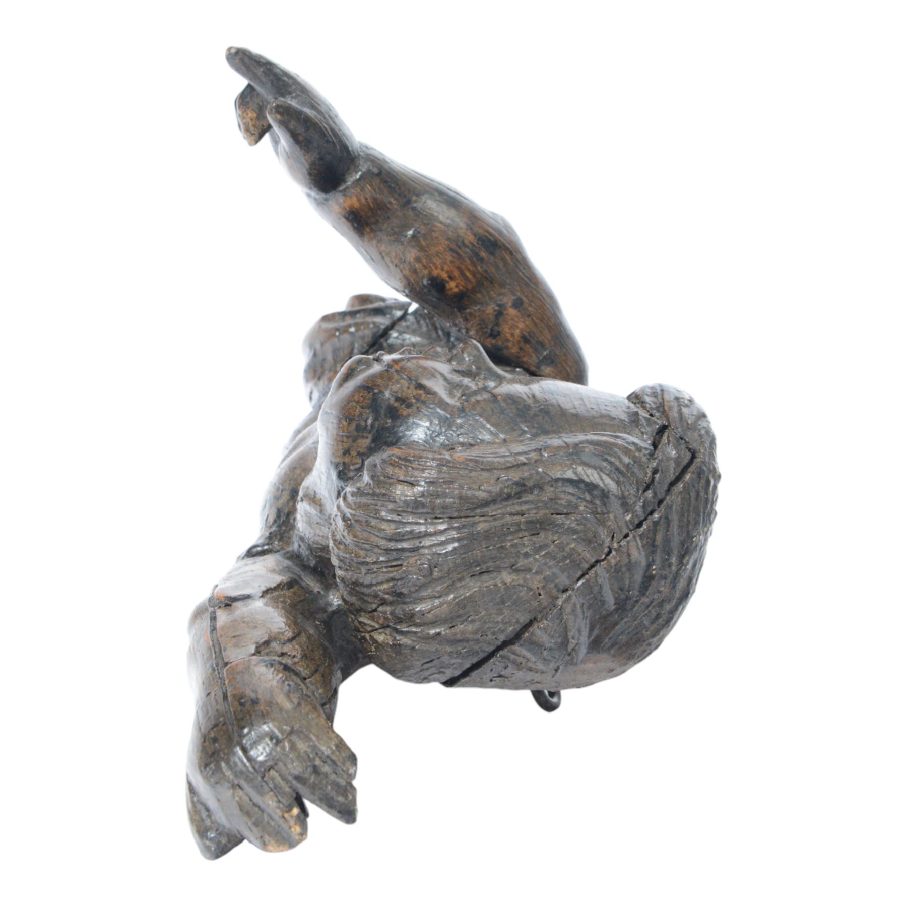 17th century carved figure of a putto, modelled with arms upstretched and head turned, approximately H64cm W23cm D27cm