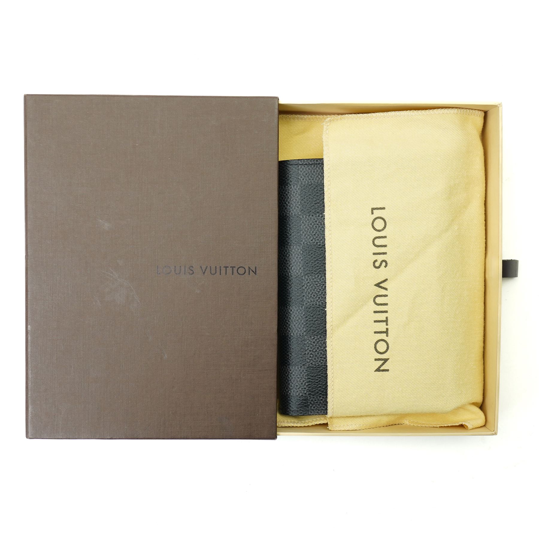Louis Vuitton Damier Graphite canvas passport holder, the black and grey checkerboard exterior opening to a crossgrain leather interior with card slots and slip pockets, stamped Louis Vuitton Paris and made in Spain, together with original Louis Vuitton box and dust cloth