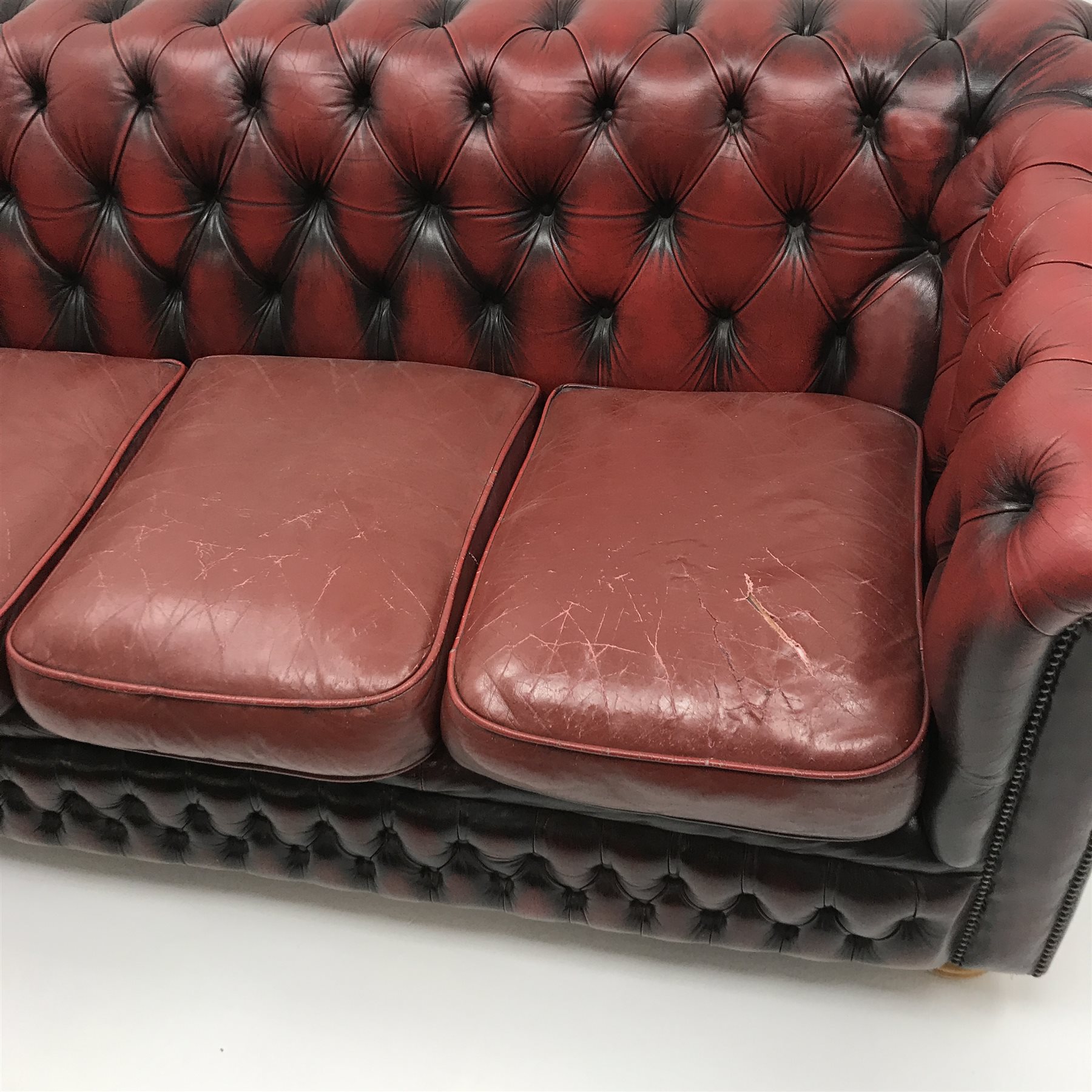Three seat Chesterfield sofa upholstered in deep buttoned Ox blood