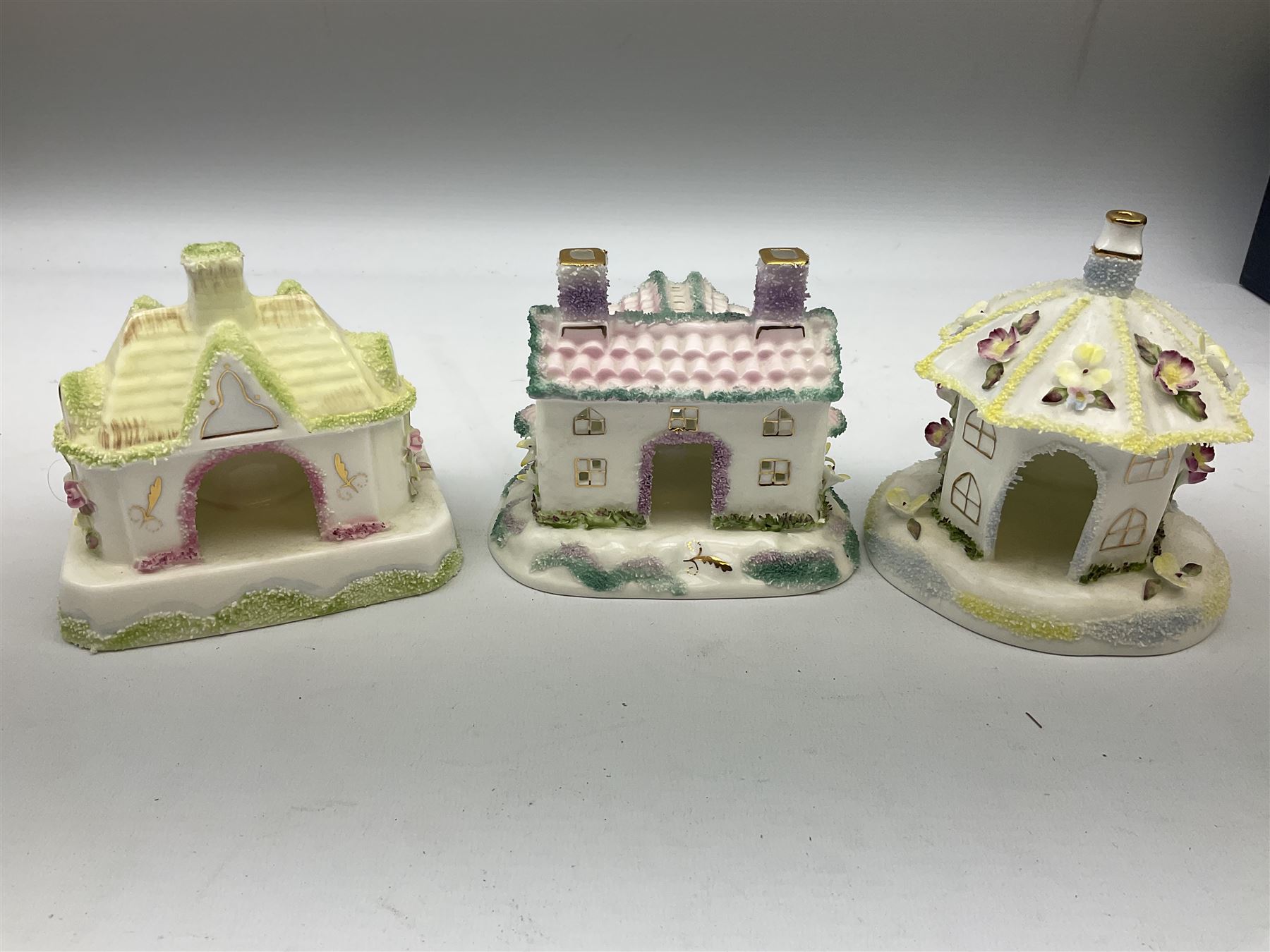 Twelve Coalport bone china pastille burner cottages, to include Fortune Towers, Summer Palace, The Vinery, Springtime Cottage, Dream Villa, Half Moon House, etc, all with original boxes and some with certificates 