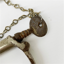 Pair of 1920's Hiatt nickel plated handcuffs marked 'Warranted Wrought' with screw-in key and a 'Metropolitan' whistle