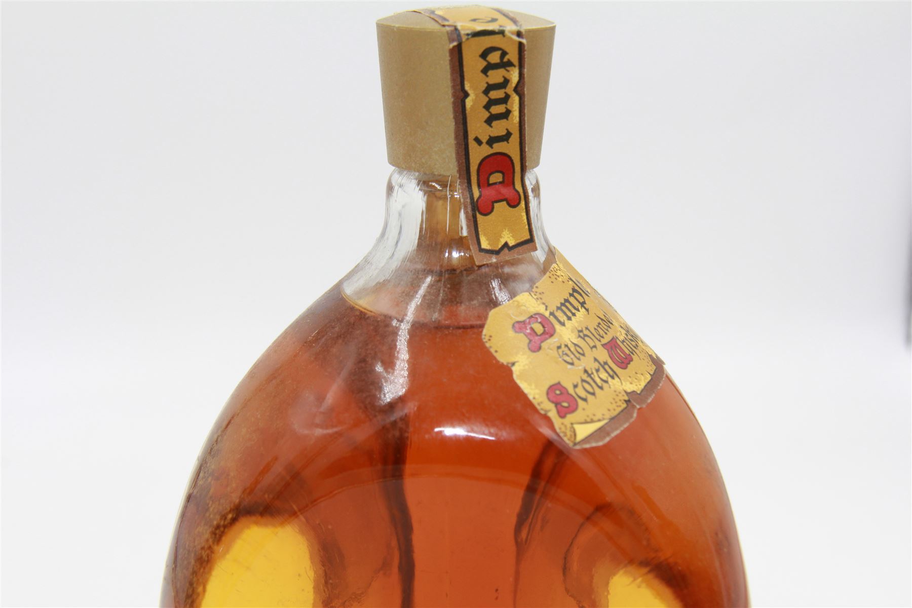 Three bottles of John Haig & Co whiskey, comprising The Original Dimple, 15 year old de luxe Scotch whisky 70cl, 40% Vol and two Dimple, Old Blended Scotch whiskey 20fl oz 70% proof (3)