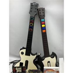 Nintendo Wii console, four controllers with cases and four nunchucks, Wii sensor bar, balance board and dance mat. Guitar hero wireless guitar for Wii and Redoctane wired guitar. Nintendo DS lite handheld gaming console, console and game cases and Guitar Hero Redoctane Guitar Grip. Selection of Nintendo Wii and Nintendo DS lite games to include Super Mario Galaxy, Guitar Hero, Wii Fit, Legend of Zelda games etc. Archos AV400 Series pocket video recorder with accessories, cradle and remote, in three boxes