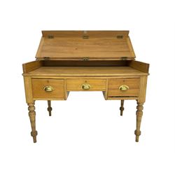 Early 20th century light oak kneehole desk, rectangular hinged top, fitted with frieze drawer flanked by two deep drawers, raised on ring turned supports