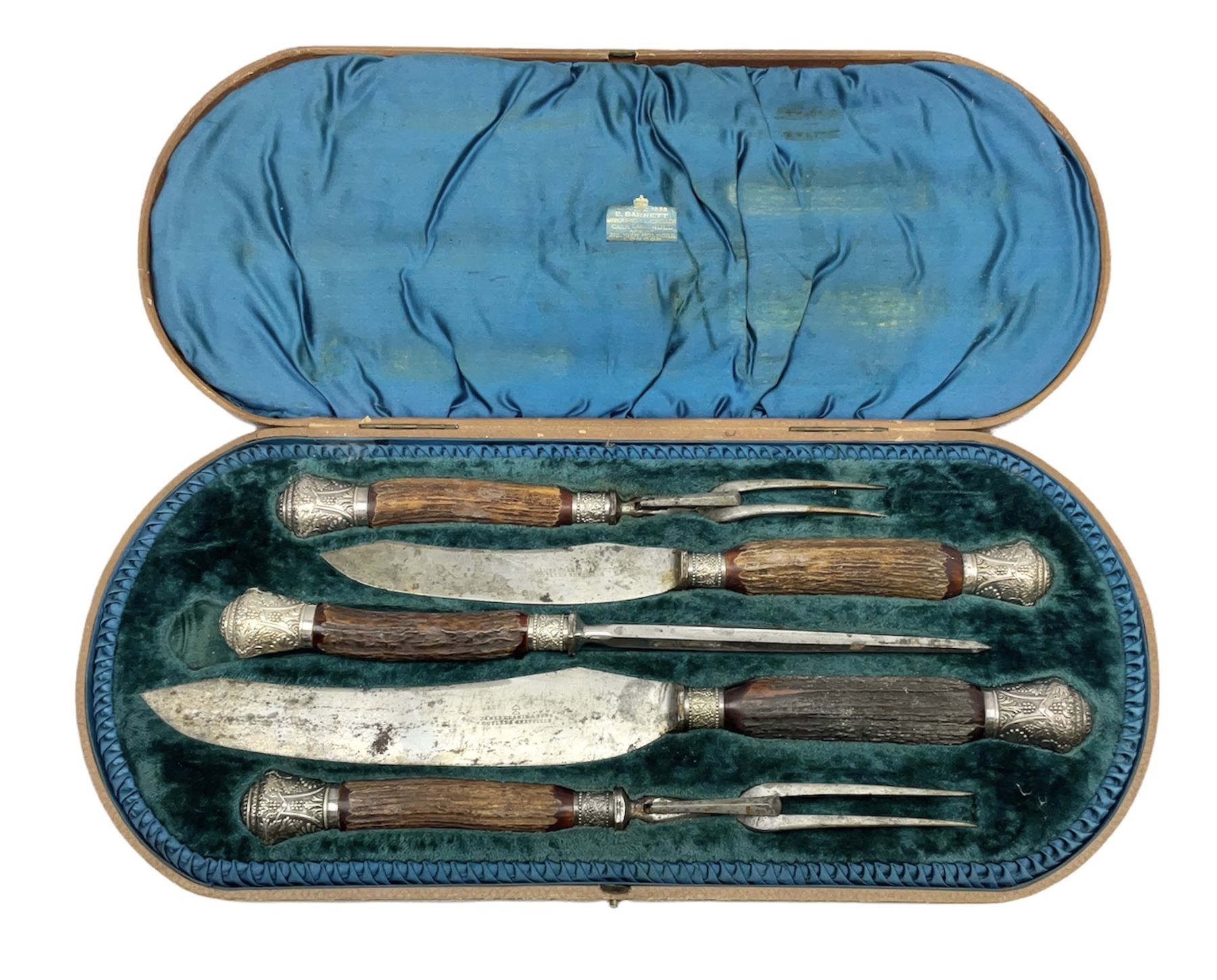 Victorian carving set, the blades stamped James Deakin and Son, Cutlers Sheffield, with part antler handles and silver plated foliate mounts, in B. Barnett of Hull lined fitted case, L47cm