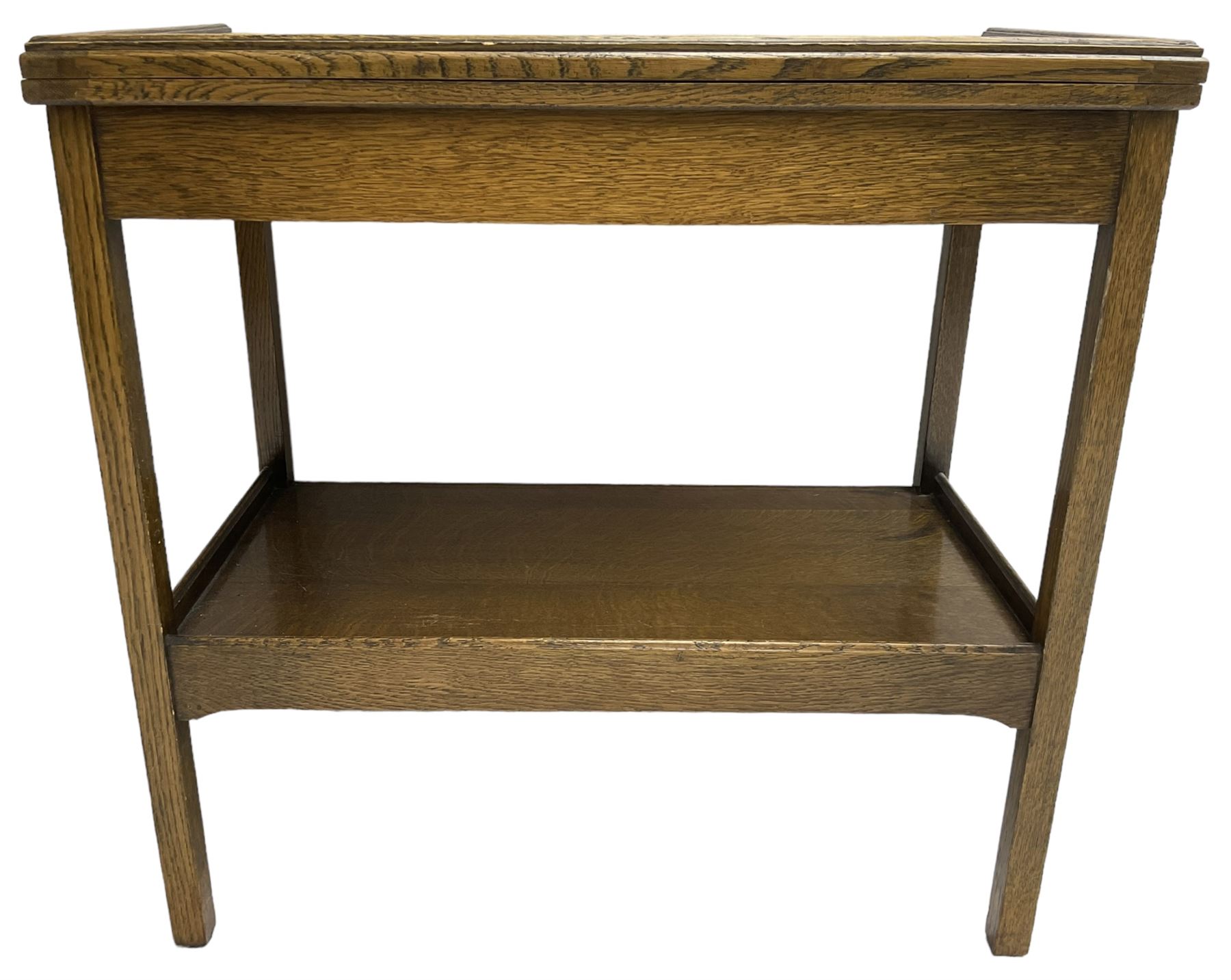 Early 20th century oak card table, fold-over and swivel rectangular top with baize lining, square supports united by undertier 