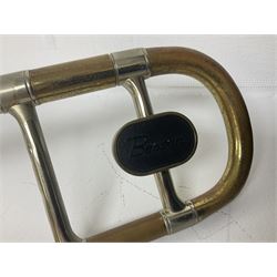 Three brass trombones comprising Elkhart Ind. USA 'CONN' model no.72H; Besson 'Concord'; and Selmer Distributed 'Lincoln'; two in carrying cases; and German B & M 'Champion' brass trumpet (4)
