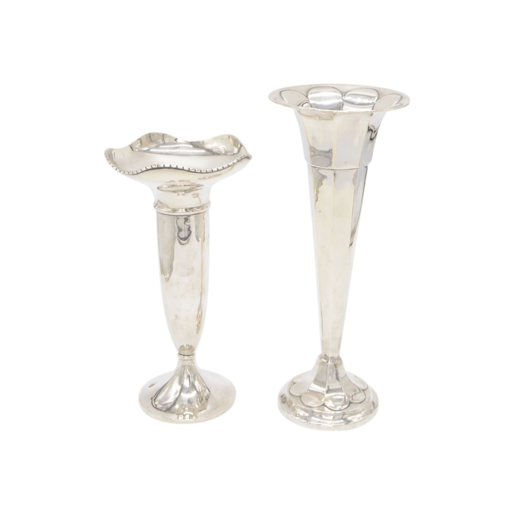 Two 1920s silver mounted trumpet vases, the first example of faceted form, hallmarked James Deakin & Sons, Sheffield 1921, the second example with fluted rim, hallmarked Walker & Hall, Birmingham 1922, tallest H25cm