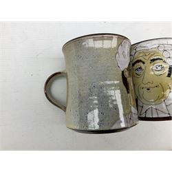 1960s Chelsea Pottery mug decorated with barrister by Joyce Morgan, signed JEM, together with a similar example depicting a doctor, H11.5cm, both signed beneath