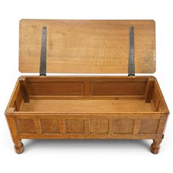 Mouseman - 1950s adzed oak blanket chest of unusual proportions, the rectangular hinged top with canted corners, over a sextuple panelled front, raised on turned octagonal feet, carved with mouse signature, by the workshop of Robert Thompson of Kilburn