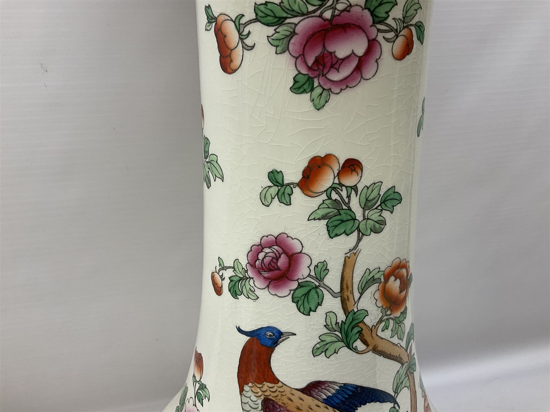 Large ceramic Jardiniere on stand, decorated with an oriental pheasant perched upon branches blossoming with peonies and foliage on white ground, overall H99cm