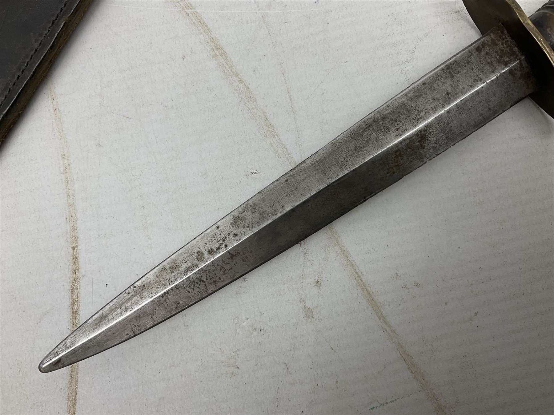 Fairburn and Sykes Commando fighting knife, 3rd pattern with 17cm double edged blade and copperised grip; no markings; in cut-down plain leather sheath L31.5cm