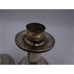 Pair of modern American silver mounted candlesticks, of plain cylindrical form, with removable drip pan, upon weighted spreading circular foot, stamped Sterling, H12.5cm