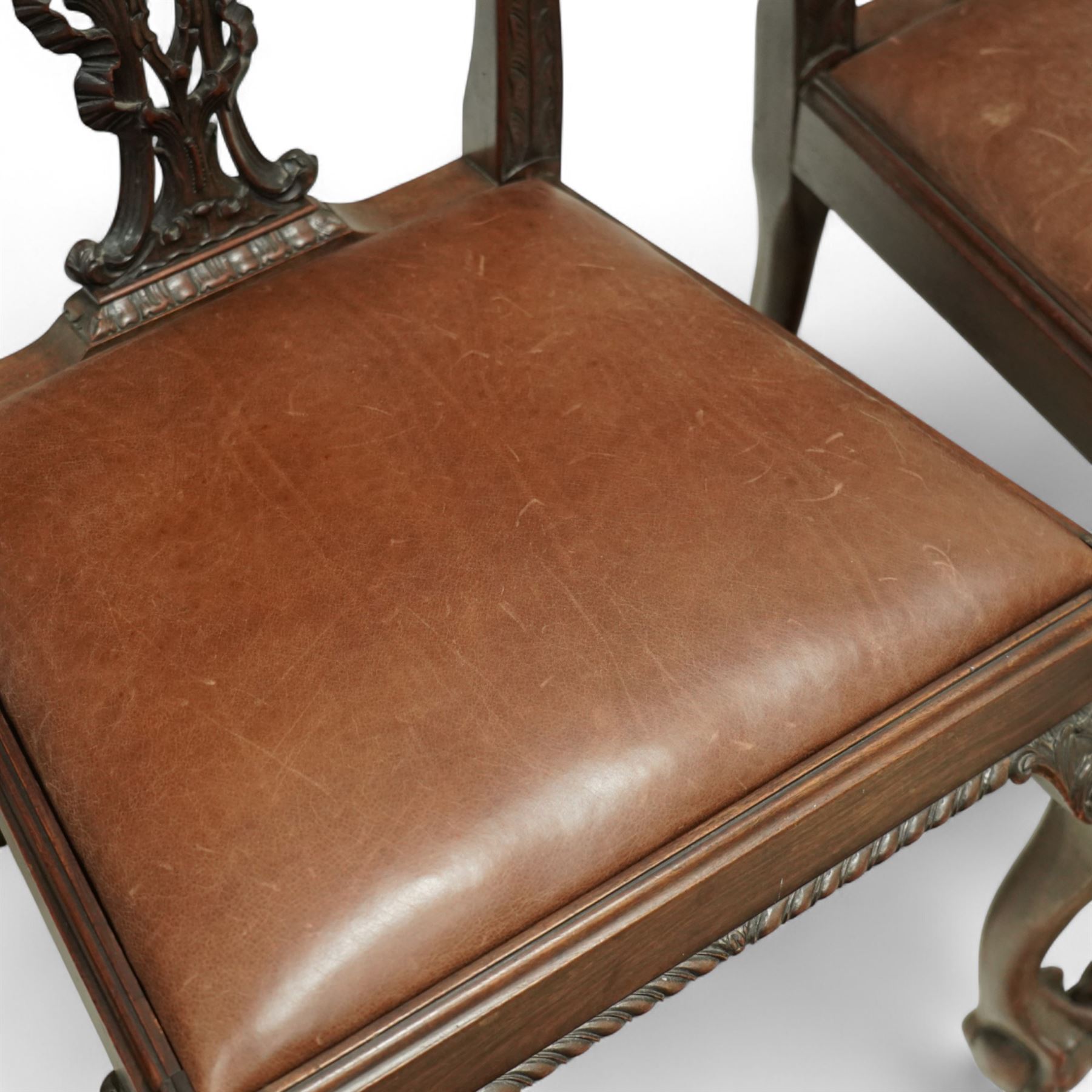 Set of eight 20th century Chippendale design mahogany dining chairs, including two carvers, each with pierced ribbon back splat carved with acanthus leaves, drop-in leather upholstered seats, moulded seat rails, on cabriole legs with ball and claw feet