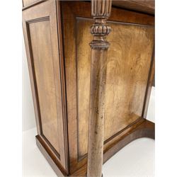 Early Victorian figured mahogany dressing cabinet, the raised shell and scroll carved back lifts to reveal rectangular easel mirror with mahogany band, flat rectangular top with tooled leather inset, slide at each side with matching leather inset, full width drawer above cupboard enclosing a series of five drawers, turned front supports, panelled front, sides and back