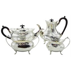 1960's four piece silver tea service, comprising teapot, hot water pot, milk jug, and twin handled open sucrier, each of oval form with foliate pierced rim, the teapot and hot water pot with simulated wooden composite handles and finials, hallmarked Stone Brothers Ltd, Sheffield 1961, approximate gross weight 56.42 ozt (1755 grams)