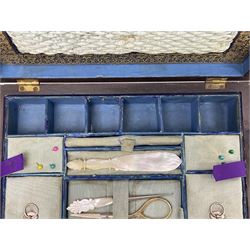 Victorian walnut sewing box, of rectangular form with brass escutcheon and inlaid brass decoration to the hinged cover, opening to reveal a lined and fitted interior and lift-out tray containing mother-of-pearl cotton reels, and other implements, H10cm D8cm W26cm