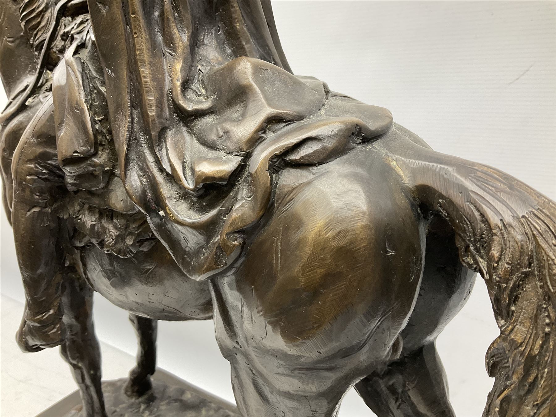 Large and impressive bronze figure of Wellington seated on a horse, on a sarcophogus shaped stepped base impressed 'Meunier Paris', the canted corners inset with battle trophies H68cm L50cm D22cm