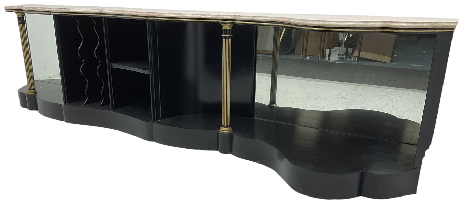 Italian ebonised and gilt serpentine corner console bookcase cabinet, shaped pink marble top over assorted shelves and dividers with fluted pilasters and mirror backs, on skirted base 