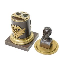 French 19th-century bronze inkwell surmounted by a bust of General Maximilien-Sébastien Foy, the cylindrical column applied with gilt-metal martial trophies and a classical caduceus of Hermes, emblematic of eloquence, commerce and diplomacy, raised on a brass socle cast with a scale pattern, on a square bronze base, the interior fitted with two glass inkwells and bronze pounce pot, H19cm
