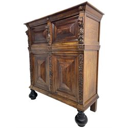 Late 17th century Flemish/Dutch rosewood and oak ‘Zeeuwse Kast’ or cupboard, projecting cornice carved with three putti masks, the uprights carved with lion masks over ribbons, flower heads and foliage, enclosed by four geometric panelled doors, lower central upright carved with flower head over foliate ribbon with bird among foliage, the escutcheon hidden by swivel berry carved cover, interior fitted with shelves, two drawers and shallow hinged cupboard, on two large turned and ebonised feet, circa 1680