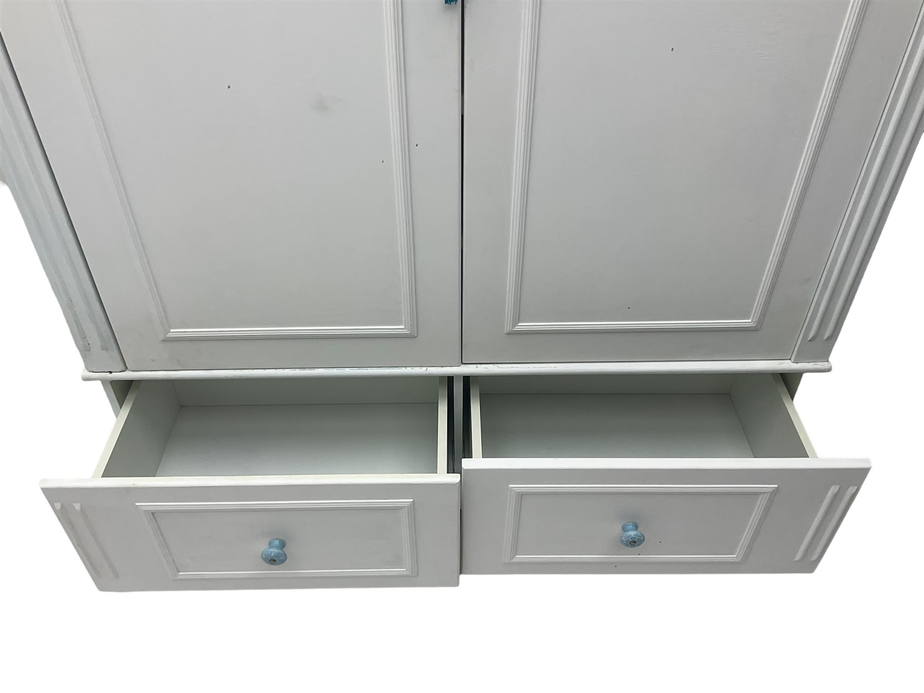 White painted double wardrobe, pierced scrolling foliate frieze over two doors enclosing hanging rail and two shelves, two drawers fitted to base, with blue ceramic handles