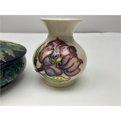 Moorcroft dish and cover, of circular form, decorated in Buttercup pattern, together with a Moorcroft vase, of baluster form, decorated in Magnolia pattern, both with printed marks beneath, tallest H9.5cm