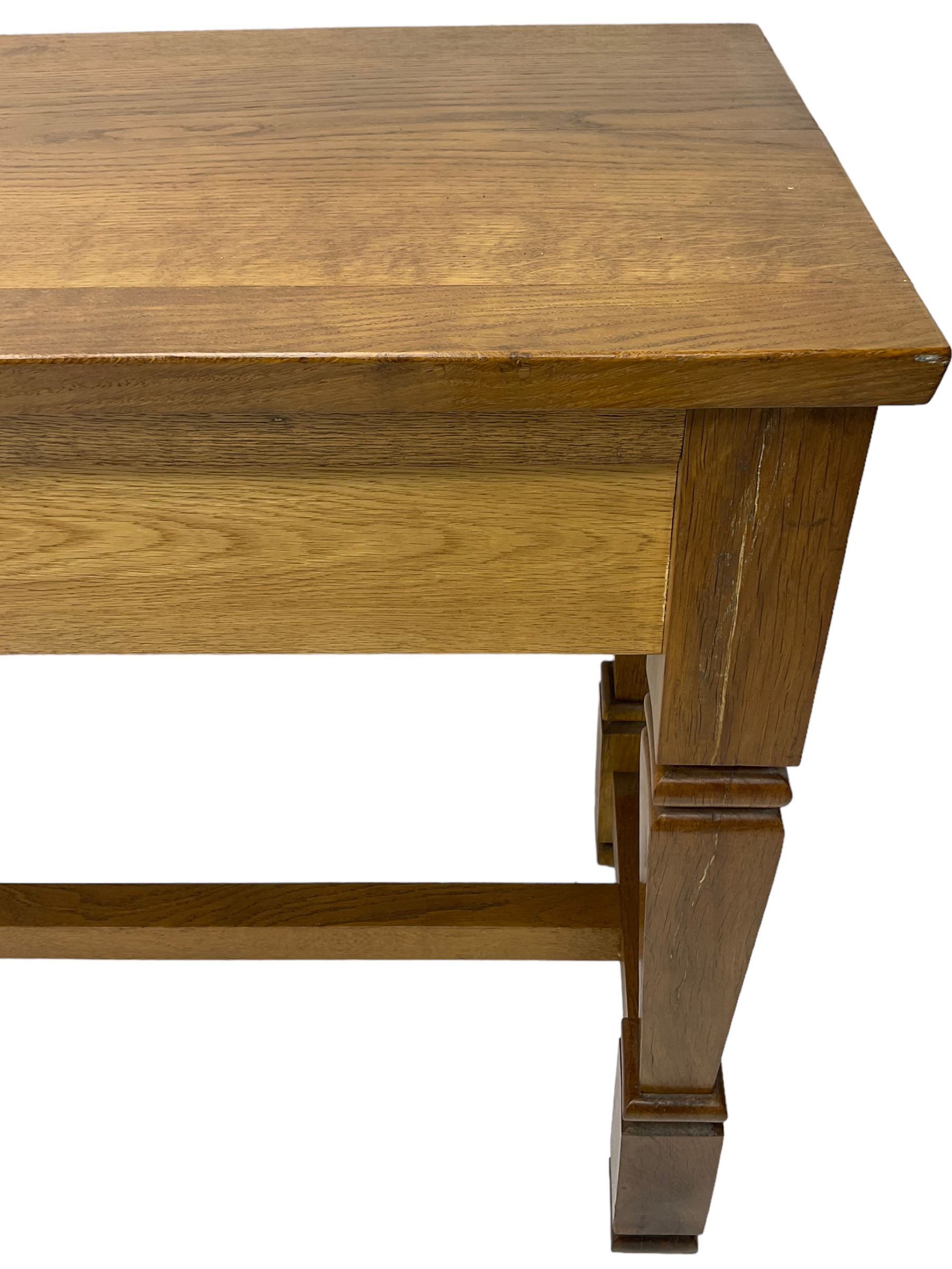 Solid oak console table, rectangular top raised on turned square supports united by stretcher