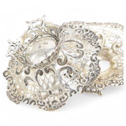 Pair of late Victorian silver bon bon dishes, of hexagonal form with embossed and pierced scrolling decoration, upon a circular pierced base, hallmarked Goldsmiths & Silversmiths Co, Birmingham 1893, W11cm, H4cm