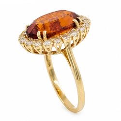 18ct gold citrine and diamond cluster ring, single oval cut citrine of approx 6.90 carat, surrounded by twenty round brilliant cut diamonds, stamped, total diamond weight approx 0.60 carat
