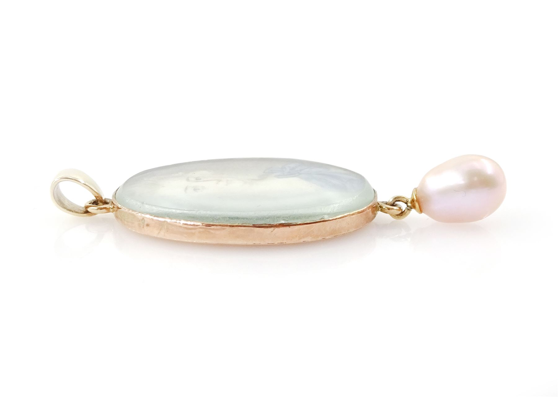 18th/ 19th century portrait pendant, set with an oval miniature of a woman wearing a blue dress on ivory, suspending a pearl drop. 
This lot has been registered for sale under Section 10 of the APHA Ivory Act
