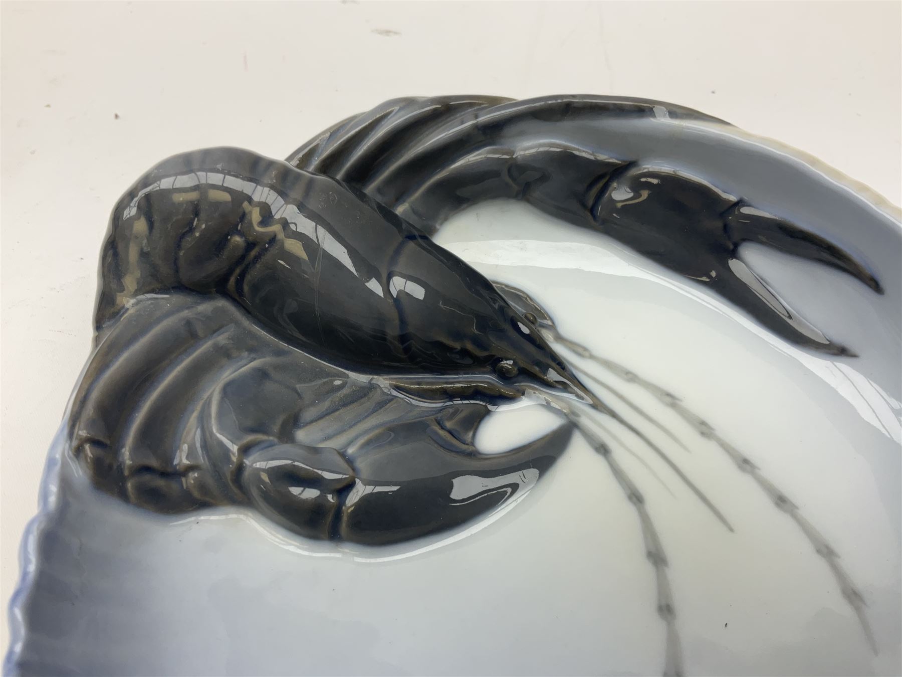 Pair of Royal Copenhagen bowls modelled as baskets and mounted with lobsters, model no 3498 and 3277, with painted and printed marks beneath, largest D19cm