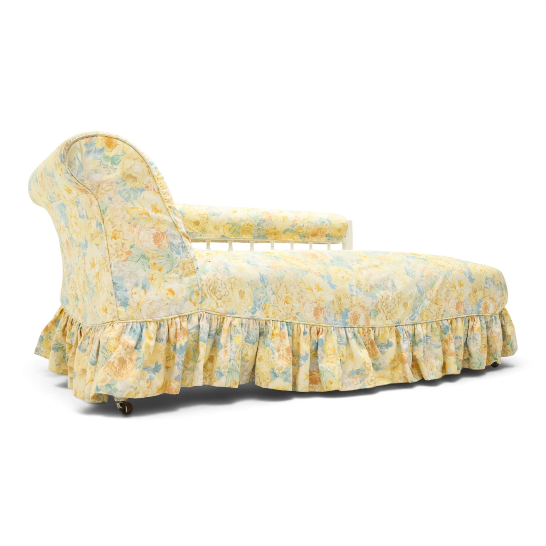 Victorian chaise longue in chintz upholstery, scrolled back with turned spindles up, raised on castors
