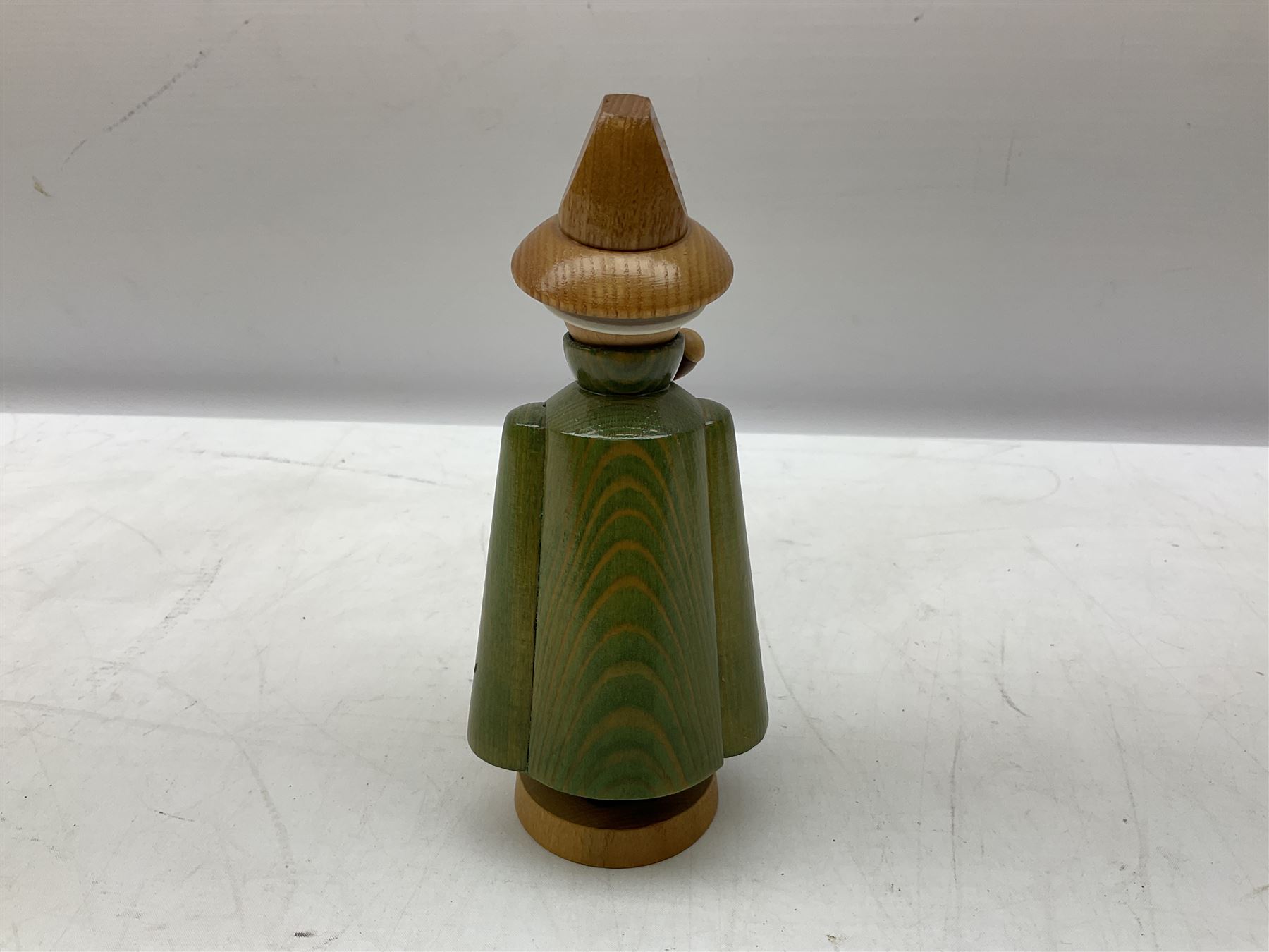 German Erzgebirgische Volkskunst folk art carved and stained wood smoking men incense burner figure, modelled smoking a pipe, with sticker label beneath, H19cm