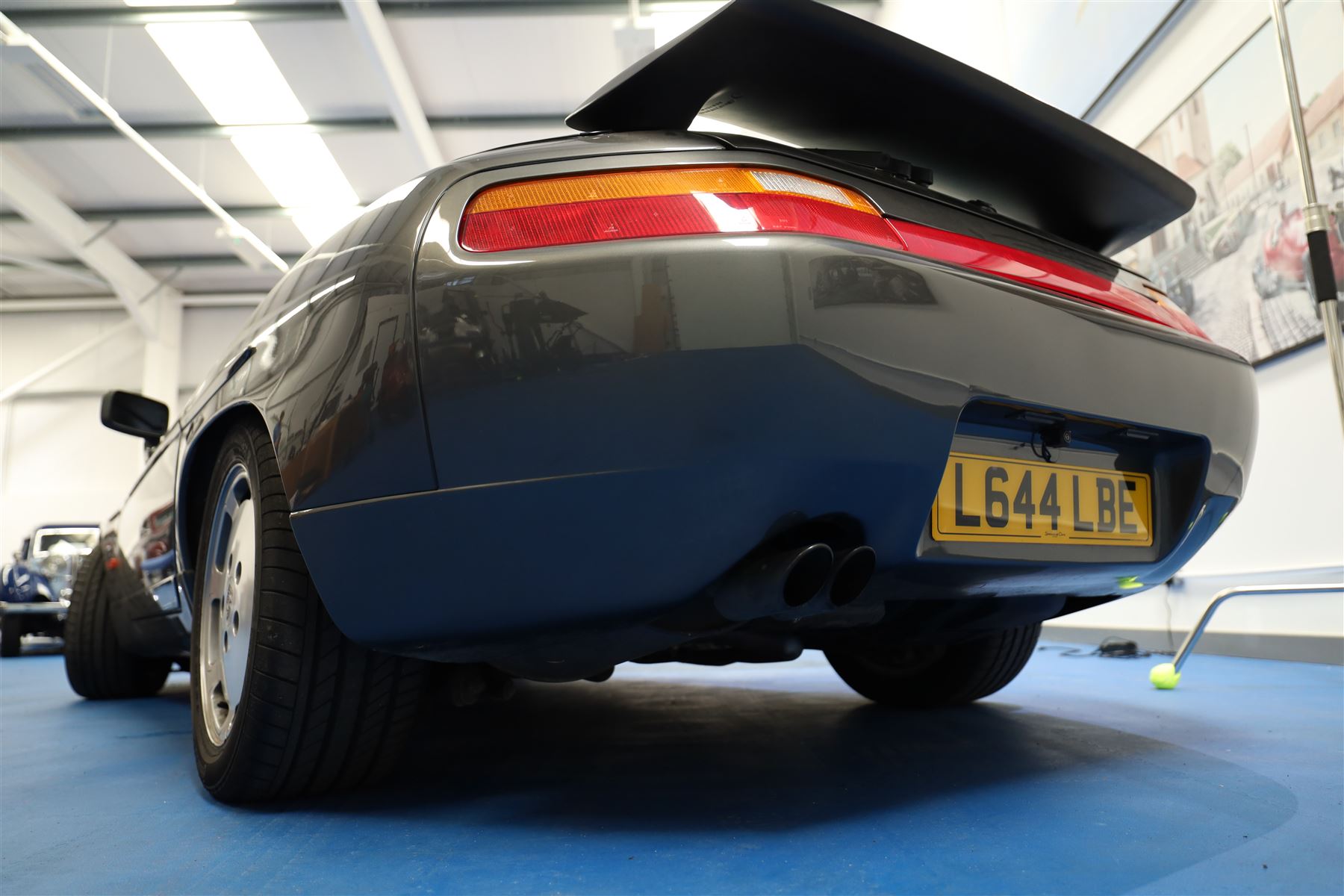 1991 Porsche 928 S4 Automatic Coupé

Registration: L644 LBE
Date of first registration as shown on V5: 1 July 1994
Porsche year of manufacture: 1991
Engine: 5.0-litre V8 petrol
Transmission: Automatic
Odometer reading: 37,886 kilometres (approximately 23,541 miles)
Colour: Slate Grey metallic
Interior: Black leather
V5C: Present
Keys: One
Chassis number: WP0ZZZ92ZMS800460

An exceptional Porsche 928 S4 Automatic Coupé finished in Slate Grey metallic with a black leather interior. The car displays a notably low odometer reading of just 37,886 kilometres, equivalent to approximately 23,541 miles.

The 928 S4 combined Porsche’s powerful 5.0-litre V8 engine with a sophisticated rear-mounted transaxle, creating a refined and accomplished grand tourer. This example is equipped with automatic transmission, electrically adjustable front seats, air conditioning, alloy wheels and the characteristic rear spoiler.

The car was purchased from Specialist Cars of Malton in June 2019, at which time the recorded mileage was 36,650 kilometres. The accompanying service record includes evidence of a cam belt replacement.

Presented in excellent condition throughout, the bodywork and metallic paint finish appear particularly well preserved, while the cabin retains its original character with black leather upholstery and 928-branded sill trims. A Japanese Porsche service label records maintenance entries at 31,902, 33,397 and 34,134 kilometres.

The car also features a Porsche Classic Communications Management (PCCM) upgrade system.

Features

• 5.0-litre V8 petrol engine
• Automatic transmission
• Slate Grey metallic paintwork
• Black leather interior
• Electrically adjustable front seats
• Air conditioning
• Porsche alloy wheels
• Rear spoiler
• Right-hand drive
• Odometer reading of 37,886 kilometres, approximately 23,541 miles
• Purchased from Specialist Cars of Malton in June 2019
• Recorded at 36,650 kilometres when purchased
• Service record showing cam belt replacement
• Japanese Porsche service label
• V5C present
• One key

This vehicle forms part of the Estate of the Late John Sils and is offered for sale by the Executors, confirming a genuine reason for sale.