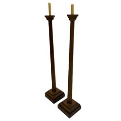 Pair of large early 20th century oak ecclesiastical candleholders, square tapered form on stepped and moulded square bases, one base inscribed 