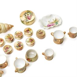 Large collection of miniature Royal Worcester hand-painted blush ivory wares, including shell shaped dish, and various covered trinket dishes, in glazed display case