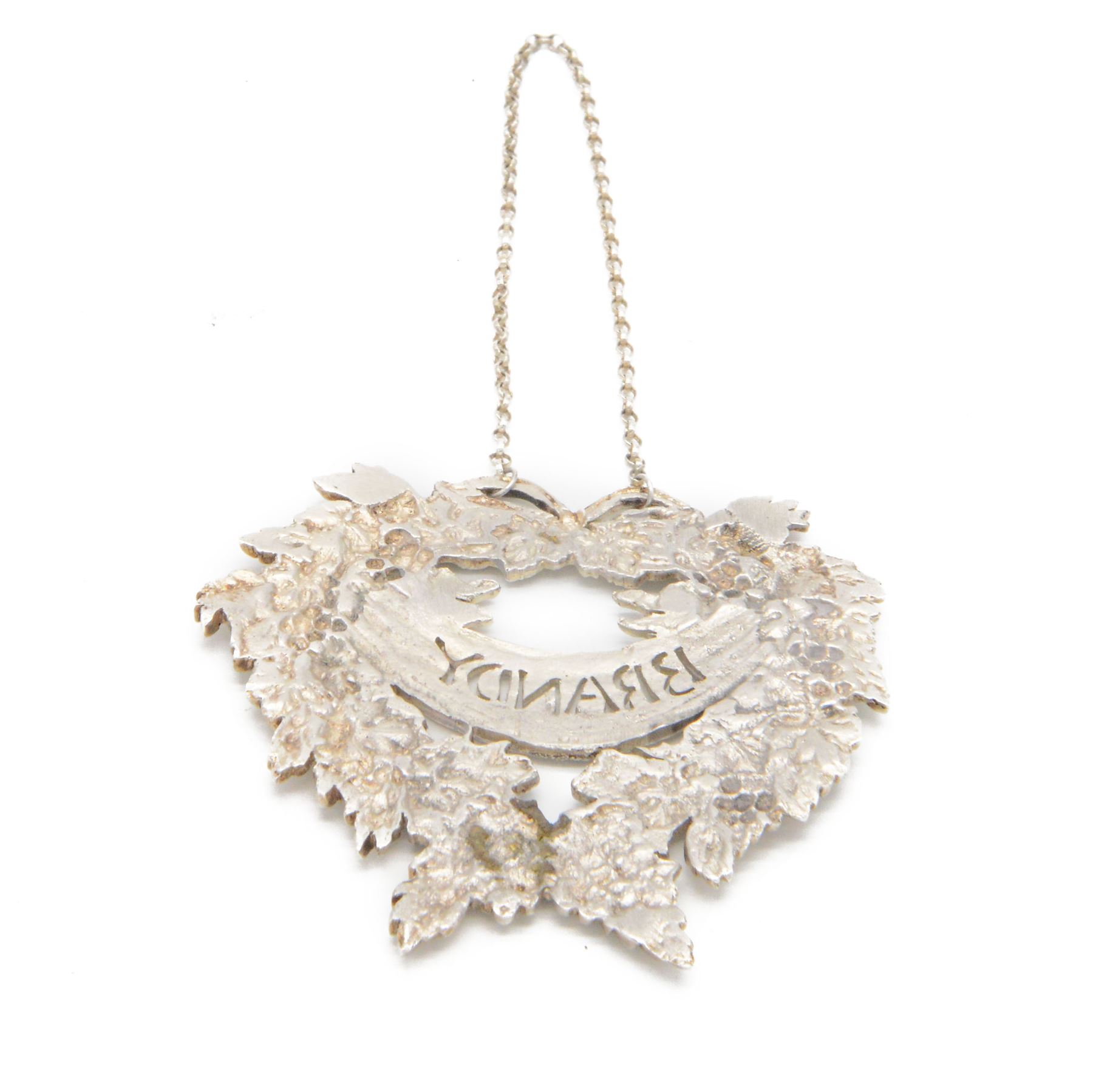 Late 20th century silver decanter label, cast in the form of a wreath of fruiting vines, with pierced 'Brandy' lettering, H7.5cm, W8cm