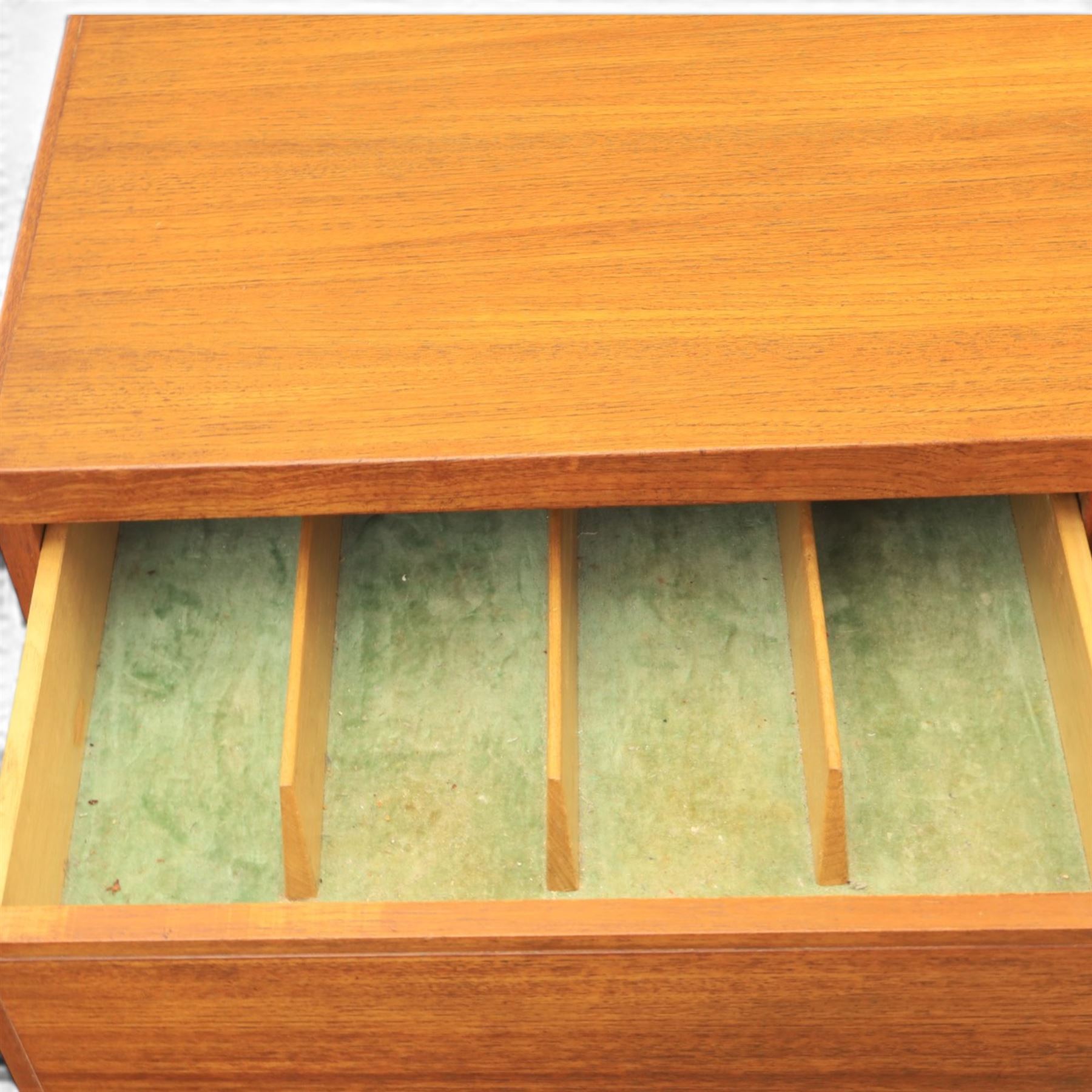 Mid-20th century teak sideboard, rectangular top above four frieze drawers with recessed handles, flanked by two cupboard doors with fall front central media cupboard
