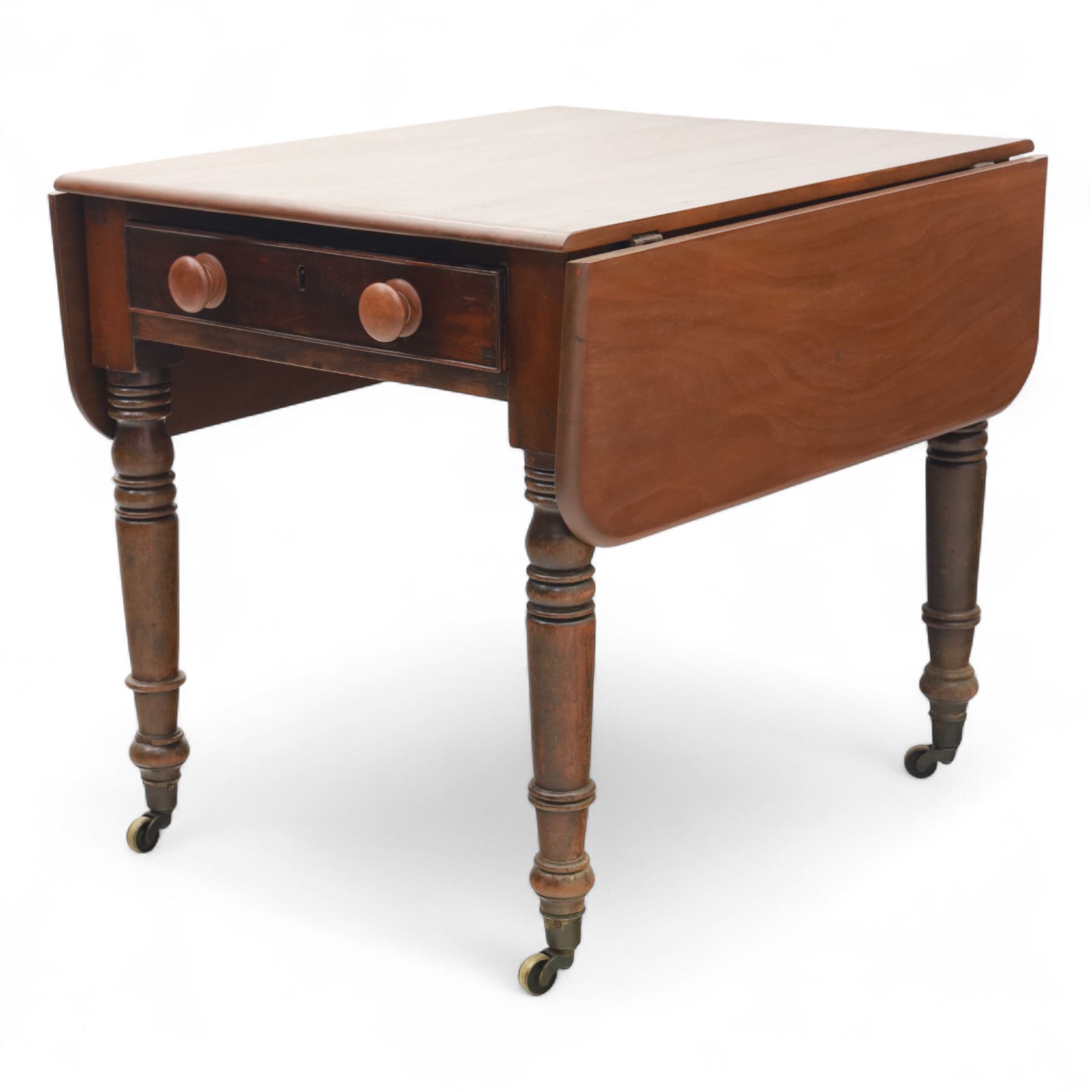 Mahogany drop-leaf Pembroke table circa 1900, with rounded rectangular top and single frieze drawer, raised on turned and tapered supports with brass castors (Extended 128cm)