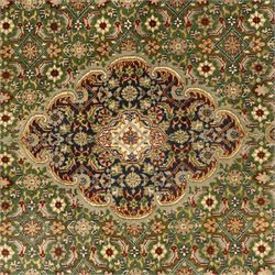 Central Persian Kashan rug, emerald green ground, with a central ivory, indigo, and brick red lobbed medallion with pendant finials, ivory spandrels, framed by multiple floral borders