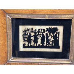 Three Regency verre églomisé or reverse painted on glass silhouettes, each depicting figural scenes, including one example of figures with puppets and cage, each within birds eye maple frame, each overall approximately H21cm W26cm