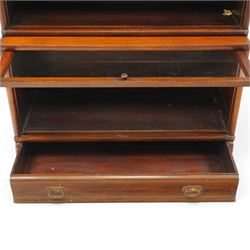 Globe Wernicke - early 20th century mahogany four-tier stacking library bookcase, the shelves fitted with glazed up-and-over doors, fitted with single drawer to the skirted base