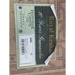 Late 20th century Royal Keshan 'Agra' hand-knotted wool rug, terracotta ground with central floral medallion and scrolling vines, enclosed by a cream border with repeating floral motifs