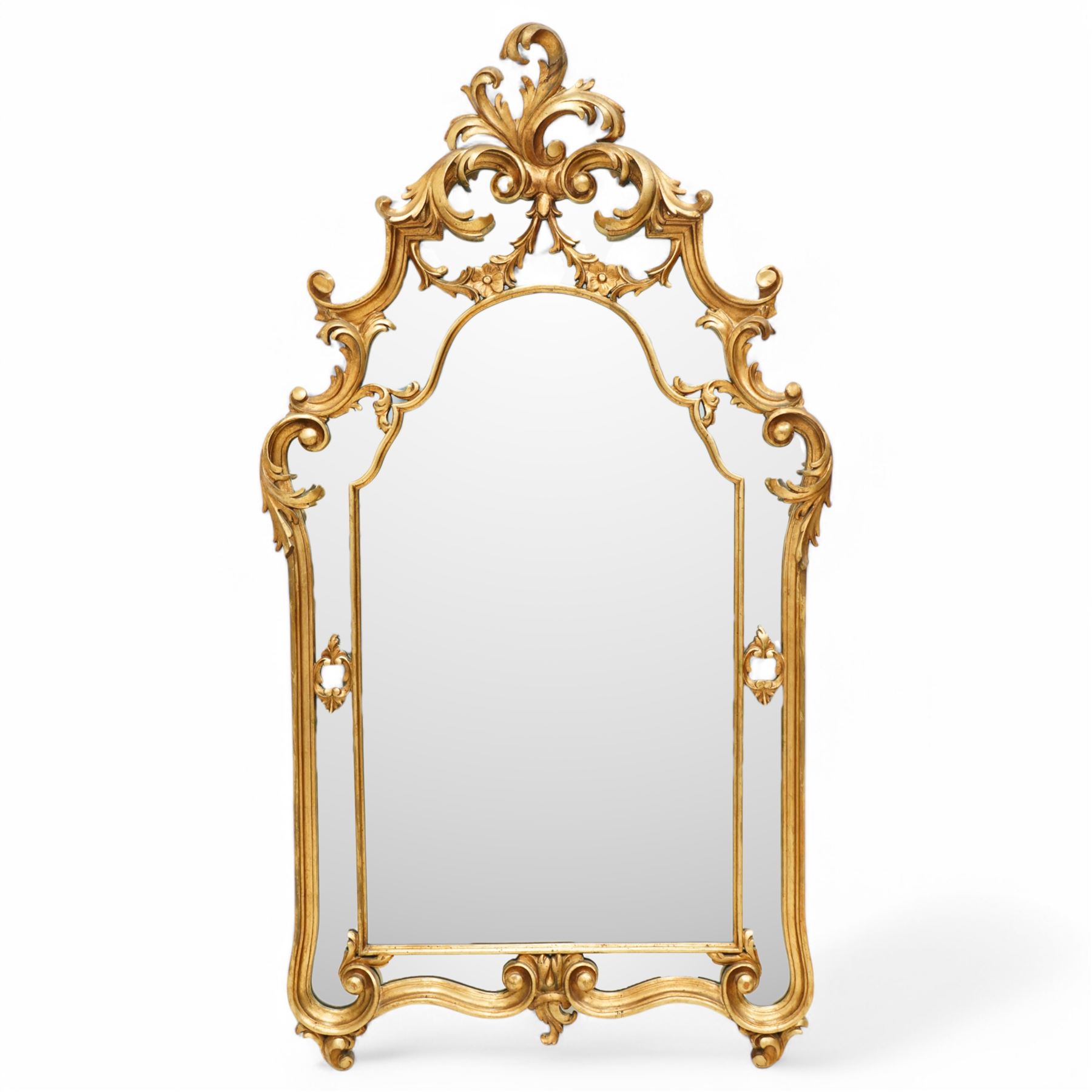 Rococo design carved gilt wood wall mirror, shaped and moulded frame decorated with scrolling leafage, plain mirror plate divided by mouldings