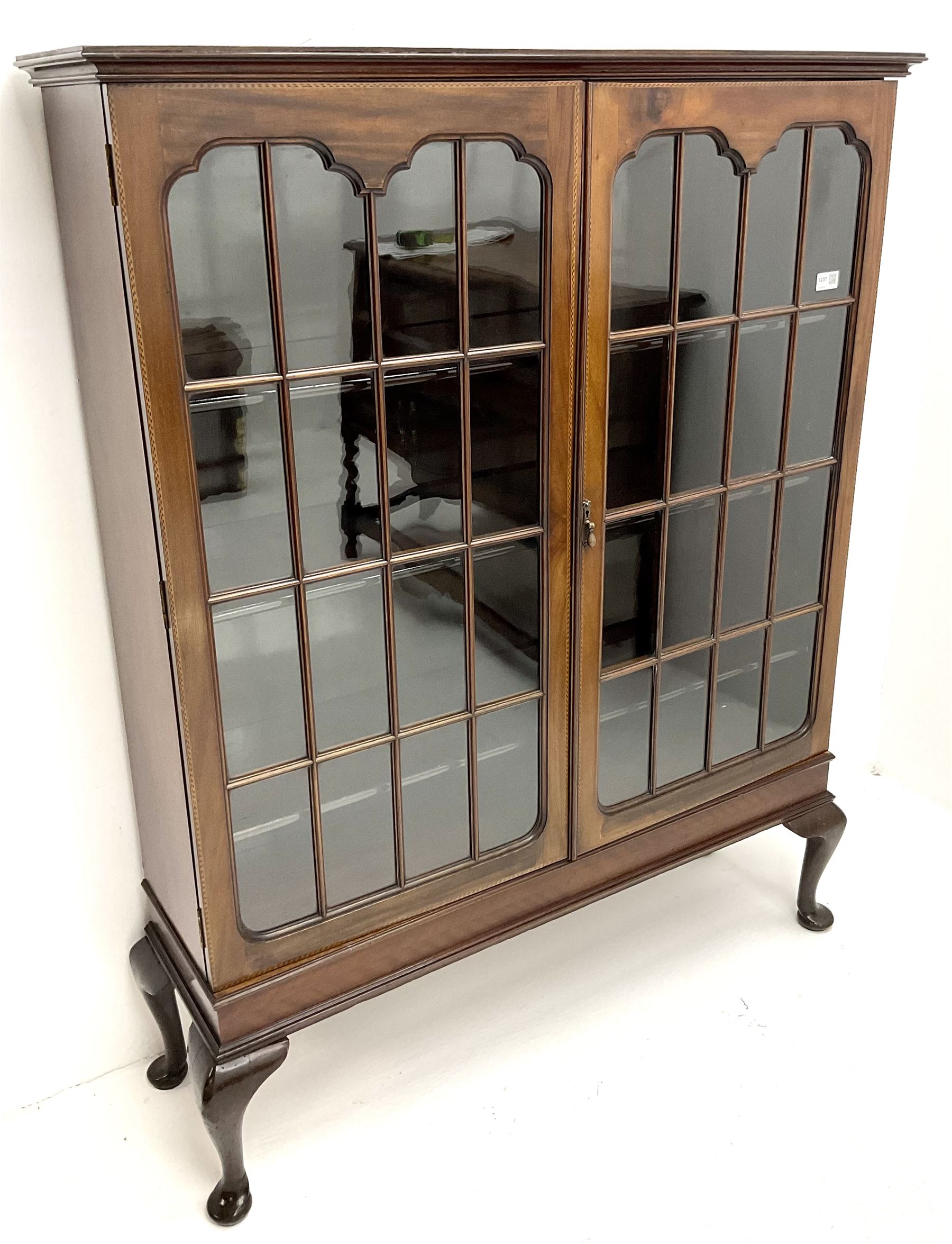 Early 20th century display cabinet enclosed by two astragal glazed doors, three adjustable shelves, cabriole legs