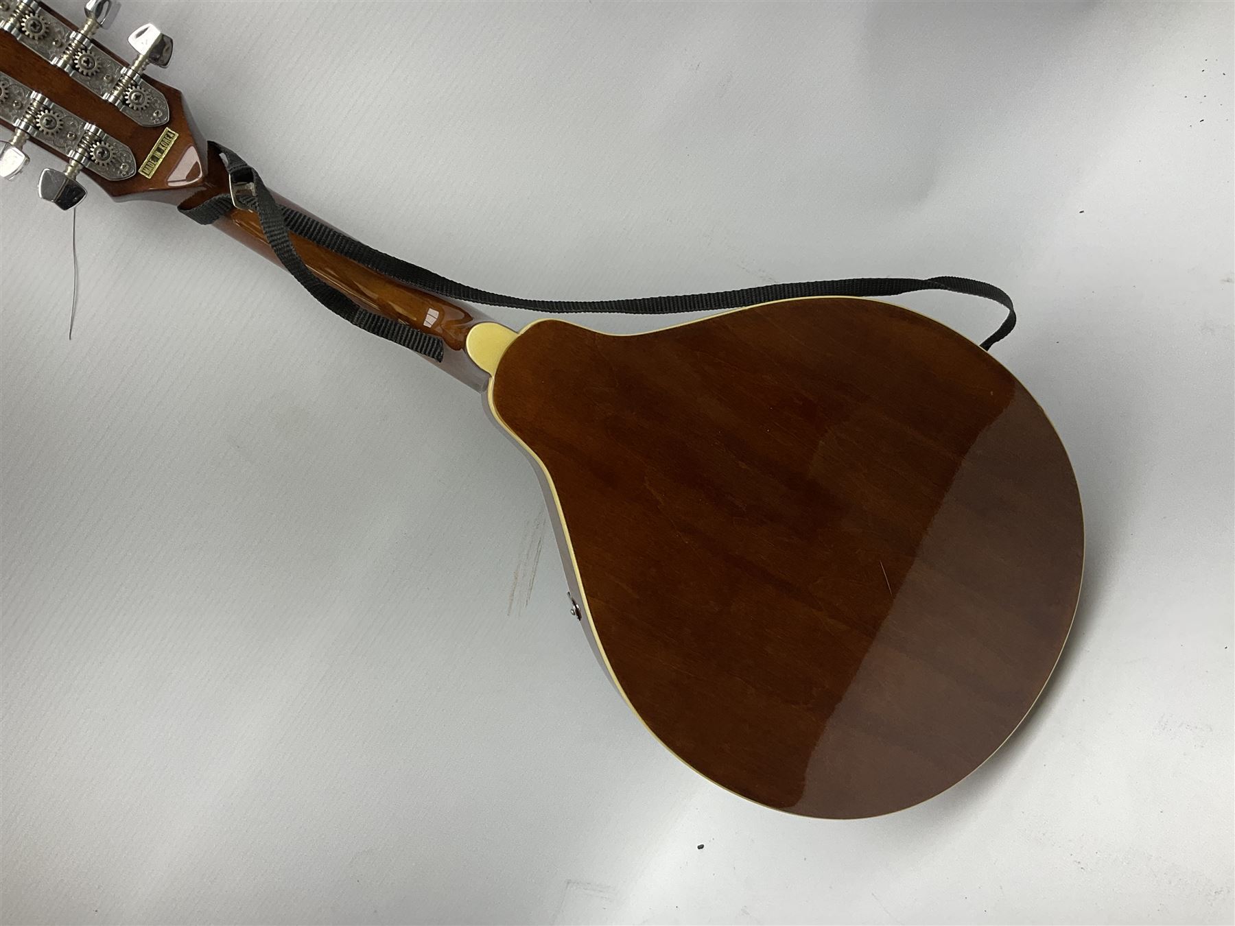 Palmer eight-string mandolin with mahogany back, simulated ivory and mother-of-pearl mounts L67cm; and Mahalo mahogany cased baritone scale ukulele, model no.U320B, L76cm; in hard carrying case (2)