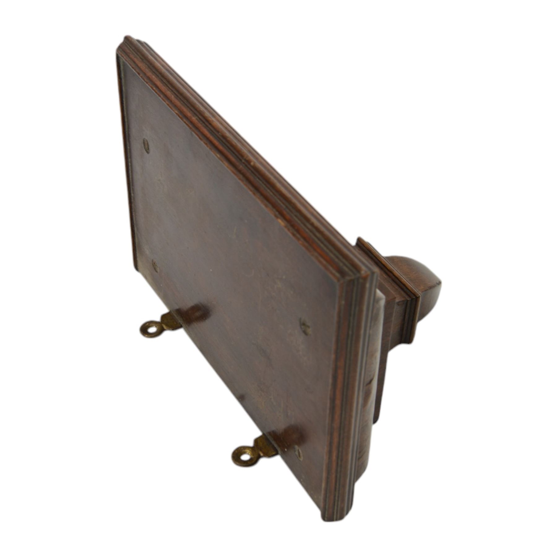 Early 20th century - mahogany cased 8-day miniature longcase clock with a matching wall mounted bracket,  break arch hood with ball finials and recessed quarter pilasters, conforming trunk with a long door and break arch top on a decorative plinth with a raised panel and stepped base, circular dial with Roman numerals and spade hands within a glazed bezel, French insert timepiece movement with a cylinder platform escapement, wound and set from the rear. With key.