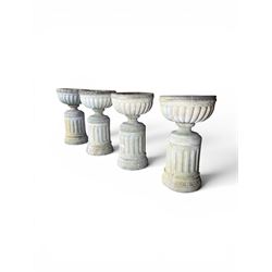 Four 20th century good quality weathered cast stone pedestal urns, circular lobed bowls with rope twist and lattice border, raised on squat base with fluted columns