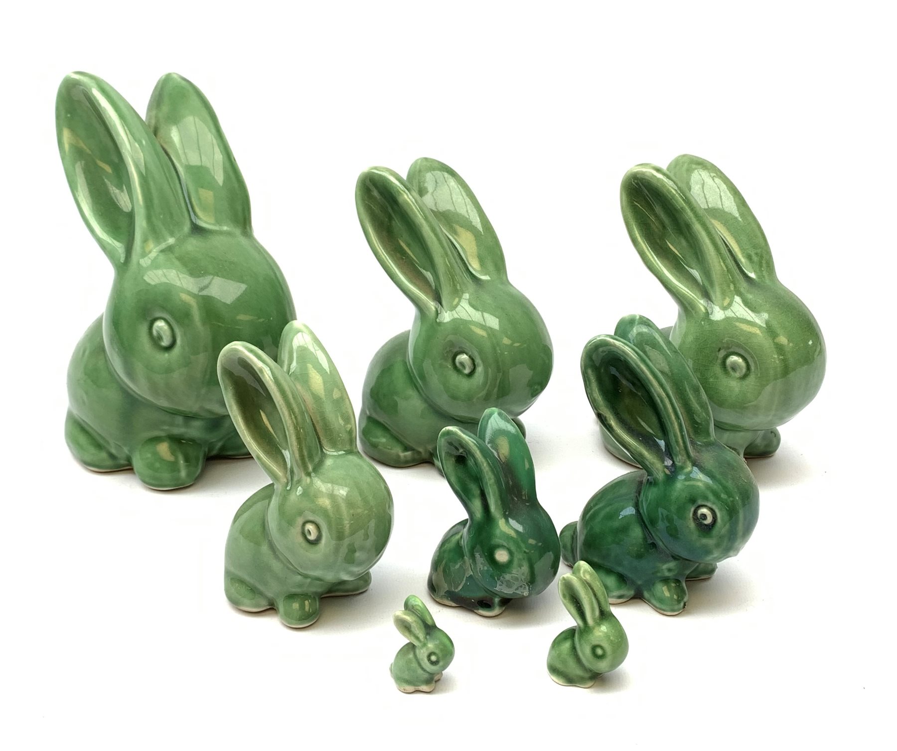 A collection of eight Denby green glazed models of the Rabbits Marmaduke and Cotton tail, various sized, largest H20.5cm, some marked. 